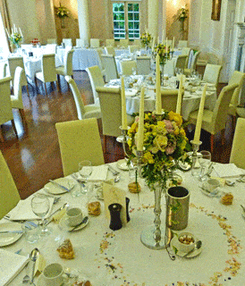 White and yellow wedding candelabra table centres