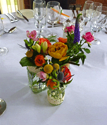 Bright, vibrant jam jar wedding table centres
