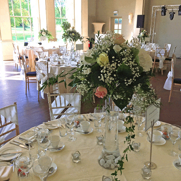 Rose and gypsophila tall vase wedding table centre
