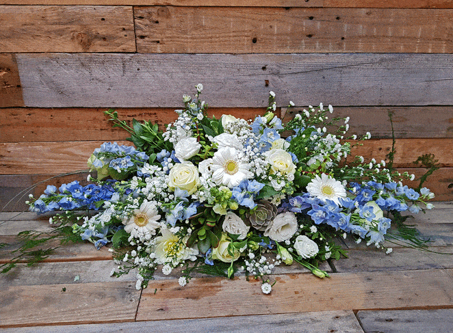 Pale blue and white top table arrangement, roses, gerbera, succulents and delphinium